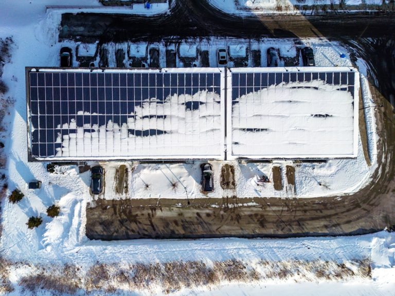Rooftop solar panels partially covered in snow. Rooftop solar panels partially covered in snow.