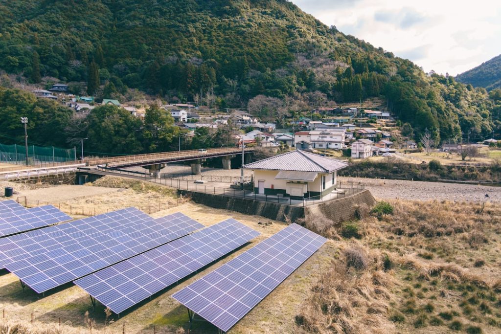 Solar panels in a rural village with mountains