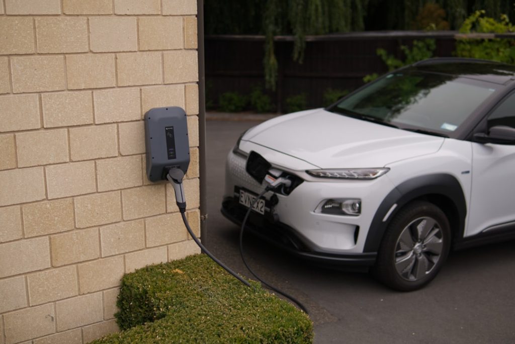 black car parked beside brown brick wall black car parked beside brown brick wall